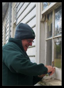 David re-puttying the cleansing room windows.