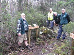 Four men standing on a trail